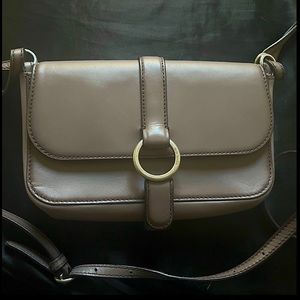 Small Michael Kors lavender purse with shoulder length straps.